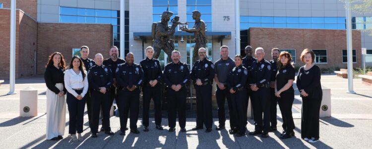 Members of Gilbert's command staff stand outside of the police department smiling in uniform.